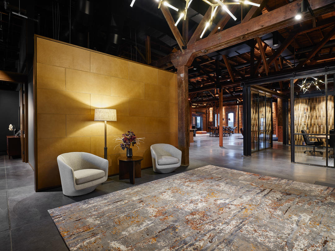 lobby of the renovated office building, with leather panel wall treatments, exposed beams.